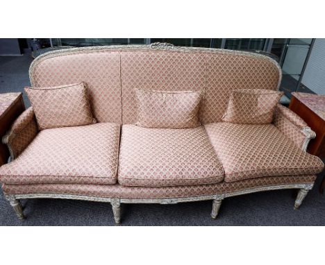 A Louis XVI style limed beech three piece suite to comprise; sofa, 205cm wide x 101cm high, and a pair of armchairs, 70cm wid