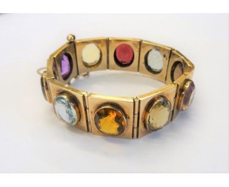 A gold and varicoloured gemstone set bracelet, formed as a row of  rectangular links, collet set with oval cut coloured gemst