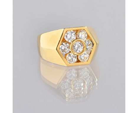 A gold and diamond seven stone cluster ring, mounted with the principal circular cut diamond to the centre, in a surround of 