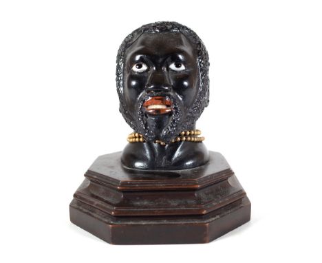 An early 20th century hardwood carved figural inkwell, pre-1918, modelled as a Nubian man, 14cm wide x 117cm high. Provenance