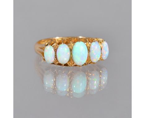 An 18ct gold and opal set five stone ring, mounted with a row of oval opals graduating in size to the centre stone, Chester p