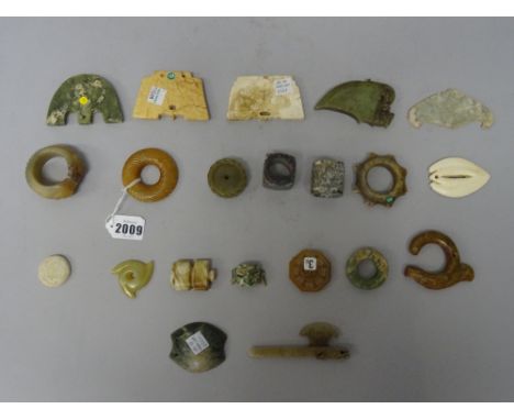 A group of twenty one Chinese archaistic jade carvings, of various tones and forms, (21).