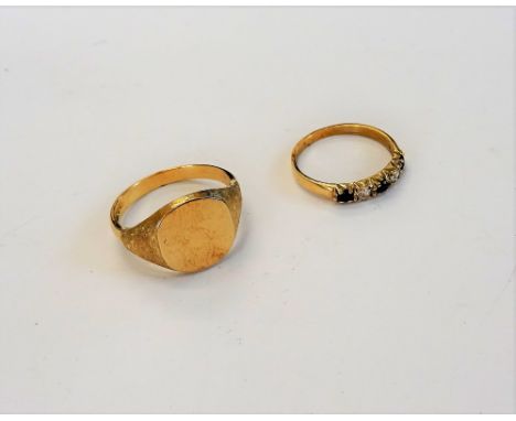 A 9ct gold signet ring, decorated with bark textured shoulders, ring size V and a half and a 9ct gold, sapphire and colourles