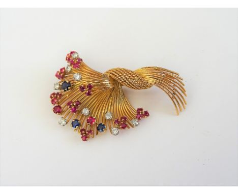A gold, diamond, ruby and sapphire set brooch, designed as a wirework spray, claw set with circular cut diamonds and coloured