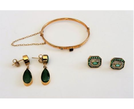 A pair of 9ct gold, emerald and diamond earstuds, each in a cut cornered rectangular design, mounted with the principal oval 