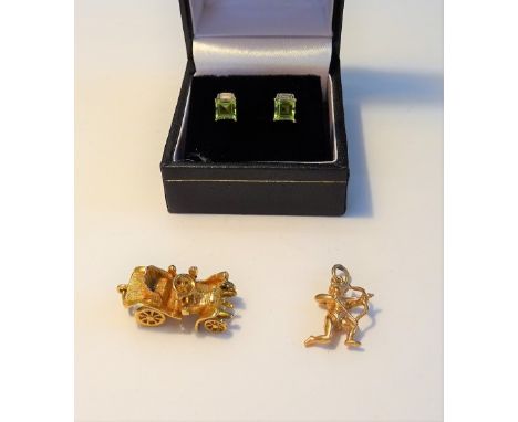 A pair of 9ct gold, peridot and diamond earstuds, each mounted with a square cut peridot and with a single baguette diamond a