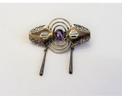 A Christian Seybold silver and amethyst single stone brooch, in an Art Deco design, mounted with the oval cut amethyst to the