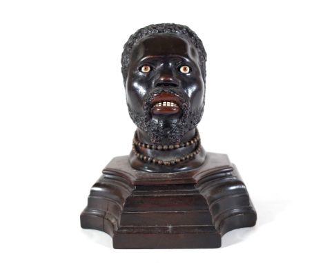 An early 20th century hardwood carved figural inkwell, pre-1918, modelled as a Nubian man, 14cm wide x 17cm high.  Provenance