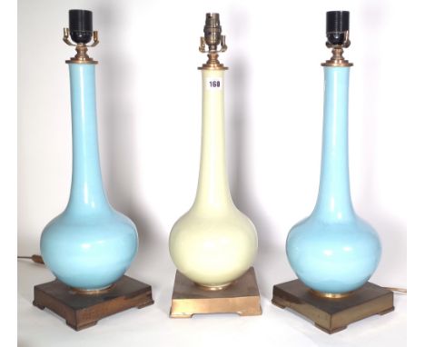 A pair of duck egg blue porcelain bottle neck vases converted to table lamps, each on a brass plinth, 44cm high and a similar