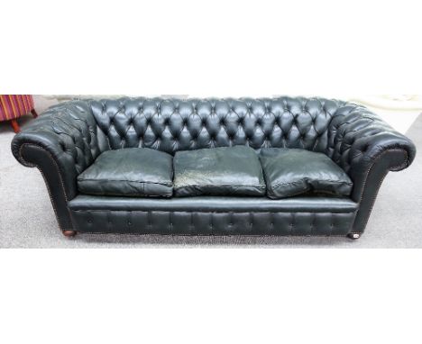 A 20th century green leather upholstered brass studded button back Chesterfield sofa on bun feet, 230cm wide x 73cm high.