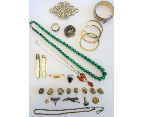 A gold bar brooch with a dog motif, weight 3.8 gms, three further brooches, a silver oval hinged bangle, three further bangle