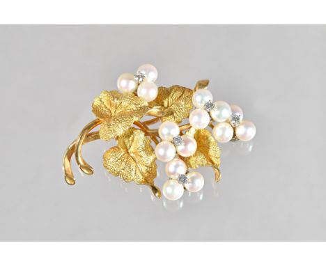 A gold, diamond and cultured pearl brooch, designed as a foliate spray, mounted with five cultured pearl set, trefoil shaped 