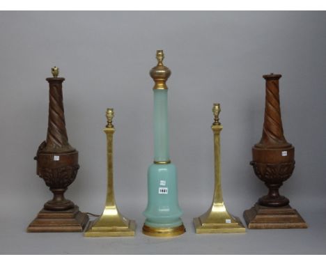 A pair of oak table lamps of carved urn form, 56cm high, an opaline blue glass table lamp on a gilt metal base, 60cm high and