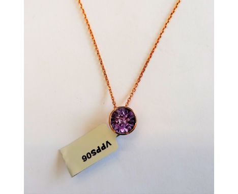 A Glenn Lehrer gold and quasar cut amethyst single stone pendant, detailed 10K, with a 9ct gold oval link neckchain on a spru