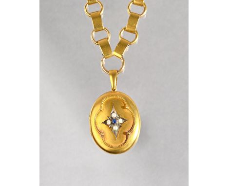A Victorian gold, sapphire and half pearl set oval pendant locket, glazed with a photographic locket compartment within, the 