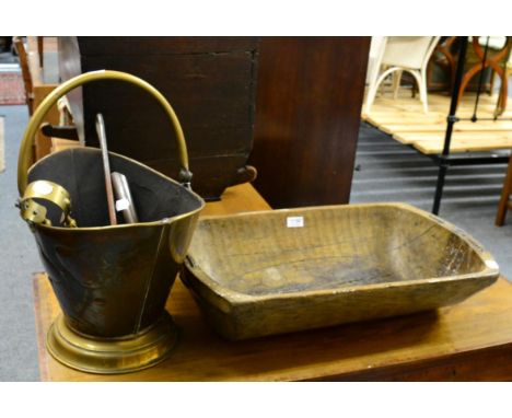 A dug out bowl, a 19th century oak crib, a small painted wheel barrow and a cast iron table lamp made from a wheel (4)