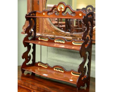 A 19th century mahogany three tier open hanging shelf with pierced fret work 