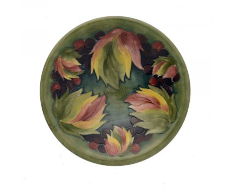 A MOORCROFT LEAF AND BERRY BOWL, C1945-49  25.5cm diam ++Light staining of the glaze inside the footrim.  Not cracked or chip
