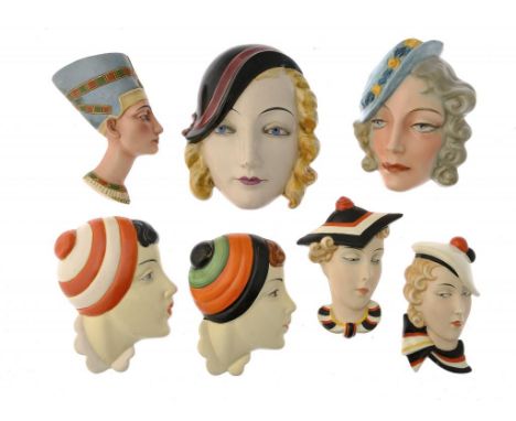 SIX CZECHOSLOVAKIAN ART DECO EARTHENWARE WALL MASKS AND A SIMILAR W GOEBEL MASK, C1930  including a Royal Dux example, 15.5-1
