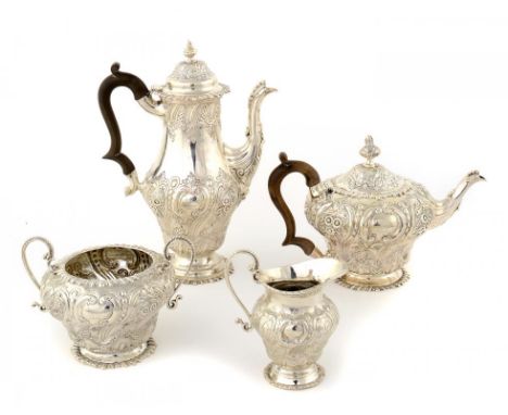 A VICTORIAN SILVER TEA AND COFFEE SERVICE  spirally lobed and richly chased with flowers, crested, coffee pot 29cm h, by W & 