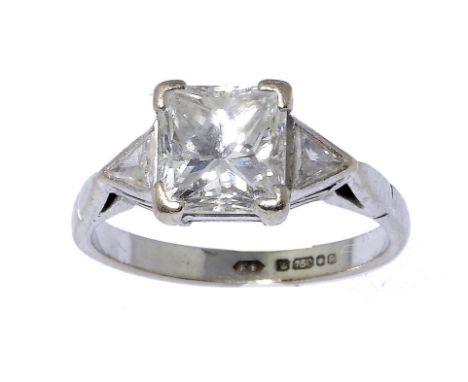 A DIAMOND RING  with princess cut diamond flanked by triangular diamonds, in 18ct white gold, London 1989, 3.8g gross, size K