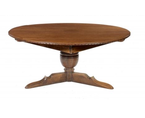 AN OAK DINING TABLE, C1920  the round top on  cup and cover support and tripod, 81cm h, 170cm diam ++Minor knocks and wear co