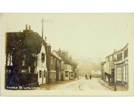 AN ALBUM OF POSTCARDS, C1905-20  real photographic including Shoeburyness, Welwyn and Elstree, others including street scenes