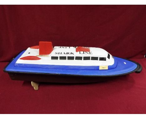 A moulded plastic model of a passenger 'Shark Line' ferry boat entitled 'Jaws'. The boat is without engine / control unit, an