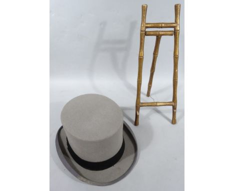 A Moss Bros grey top hat with black trim, interior dia. 20cm x 17cm, 16cm high, and a bamboo style gilt wood easel. (2)