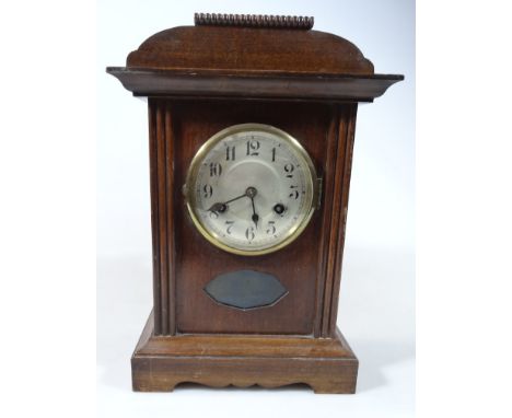 An Edwardian mantel clock, the 13cm dia. Arabic dial revealing an eight day movement, in a partially carved case on bracket f