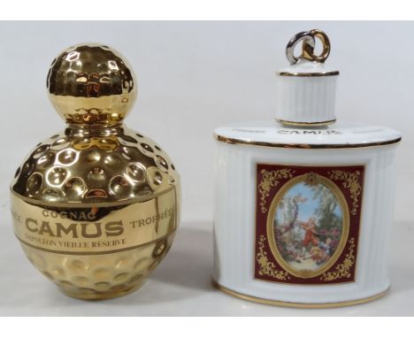 A Limoges Castel 22ct gold finish golf ball decanter and stopper, named banding, 23cm high, and a Camus Napoleon decanter. (2