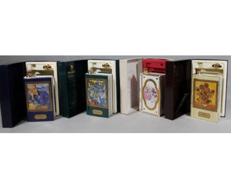 A cased Cognac Camus Special Reserve Vincent Van Gogh decanter set, 26cm high, another book shaped decanter and two others. (