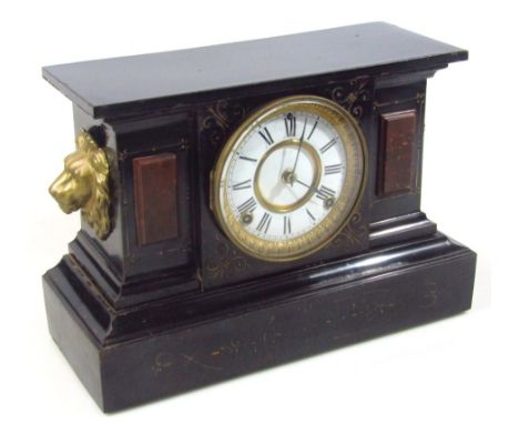 A late 19thC black slate and marble mantel clock, centred by a 11cm Roman numeric dial with eight day movement, flanked by li