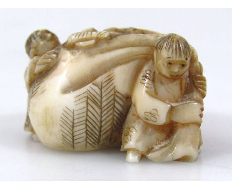 A Japanese carved ivory netsuke, of two figures hauling a very large sack, 1.7cm long.(Taisho period 1912-1926) Provenance: P