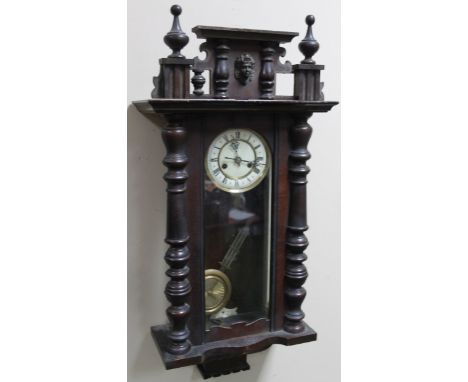 A late 19thC stained walnut Vienna wall clock, the 14cm dia., Roman numeric dial, fronting a key wind eight day pendulum swun