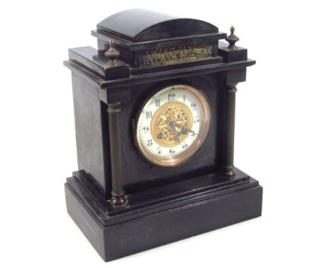 A late 19thC black slate mantel clock, in a domed top architectural case, the fancy 10cm dia. Arabic dial flanked by columns 