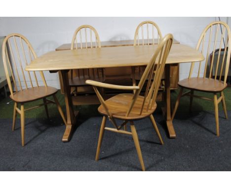 A modern Ercol light elm dining room suite, comprising oblong table, sideboard, 152cm wide, and five (4+1) hoop back chairs. 