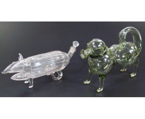 A 20thC glass spirit decanter, in the form of a dog with tail handle, in standing pose, unmarked, 17cm high, and another deca