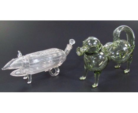 A 20thC glass spirit decanter, in the form of a dog with tail handle, in standing pose, unmarked, 17cm high, and another deca