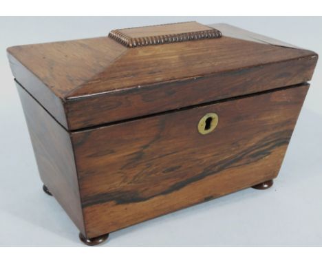 A mid-19thC rosewood sarcophagus shaped tea caddy, the shaped lid hinging to reveal a fitted interior with two compartments, 