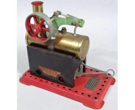 A mid-20thC Mamod stationary engine, with brass cylinder and rotating cog on part pierced base, 19cm wide.