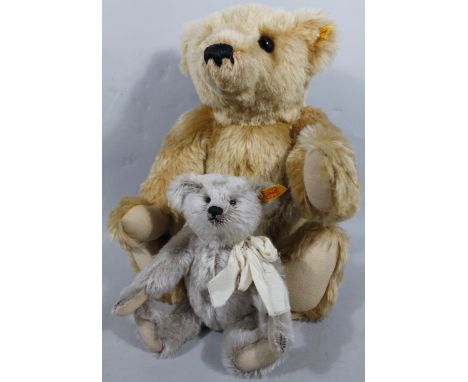 A modern Steiff blonde plush Teddy bear, with articulated limbs and ear stud, 50cm high, and another modern Steiff Teddy bear