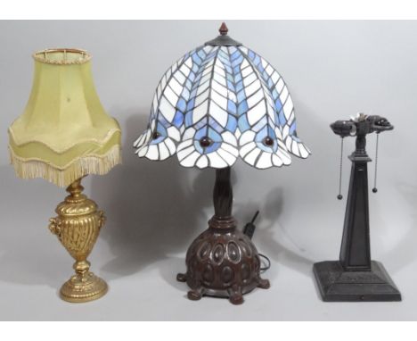 A modern table lamp, with frosted glass shade, predominantly in blue and white on a highly decorative metal stem with bulbous