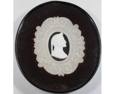 A 19thC Parian portrait plaque, raised by the profile of a gentleman, in a polished marble scroll surround, (framed), 30cm hi
