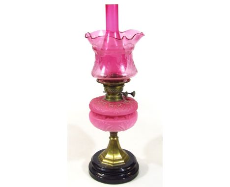 An early 20thC cranberry pink and frosted glass oil lamp, with elaborate etched shade, handkerchief top, cranberry funnel, pi