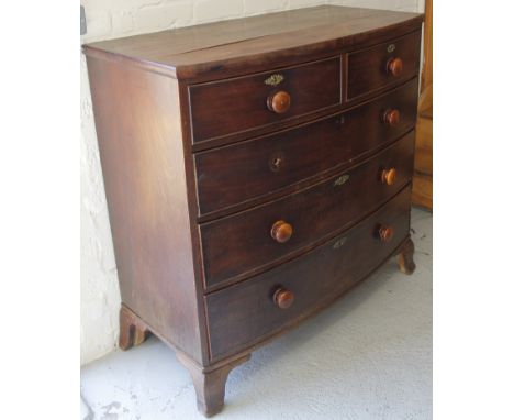 A Georgian bow front mahogany chest, of two short over three long graduated drawers, on bracket feet.