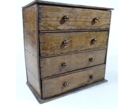 A late 19thC oak apprentice piece table top chest, of four long drawers,  containing a quantity of various bygone collectable