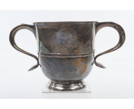 A George II two handled cup, makers mark indistinct, London 1728 Of baluster form, with two scroll handles, an applied waist 