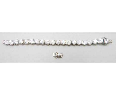 A silver paste set tennis bracelet, clasp requires repair, 34g