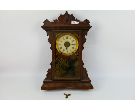 A Seth Thomas mantel clock with key and pendulum, approximately 54 cm (h). [W]
